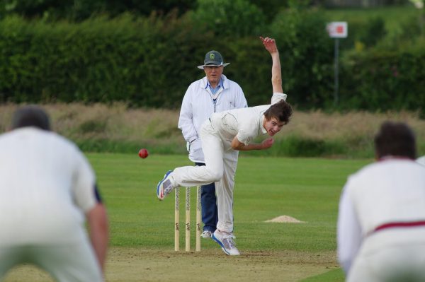 A fast bowler completing a delivery. Fast bowling places significant stresses on the back and shoulders that over time can cause many common cricket injuries