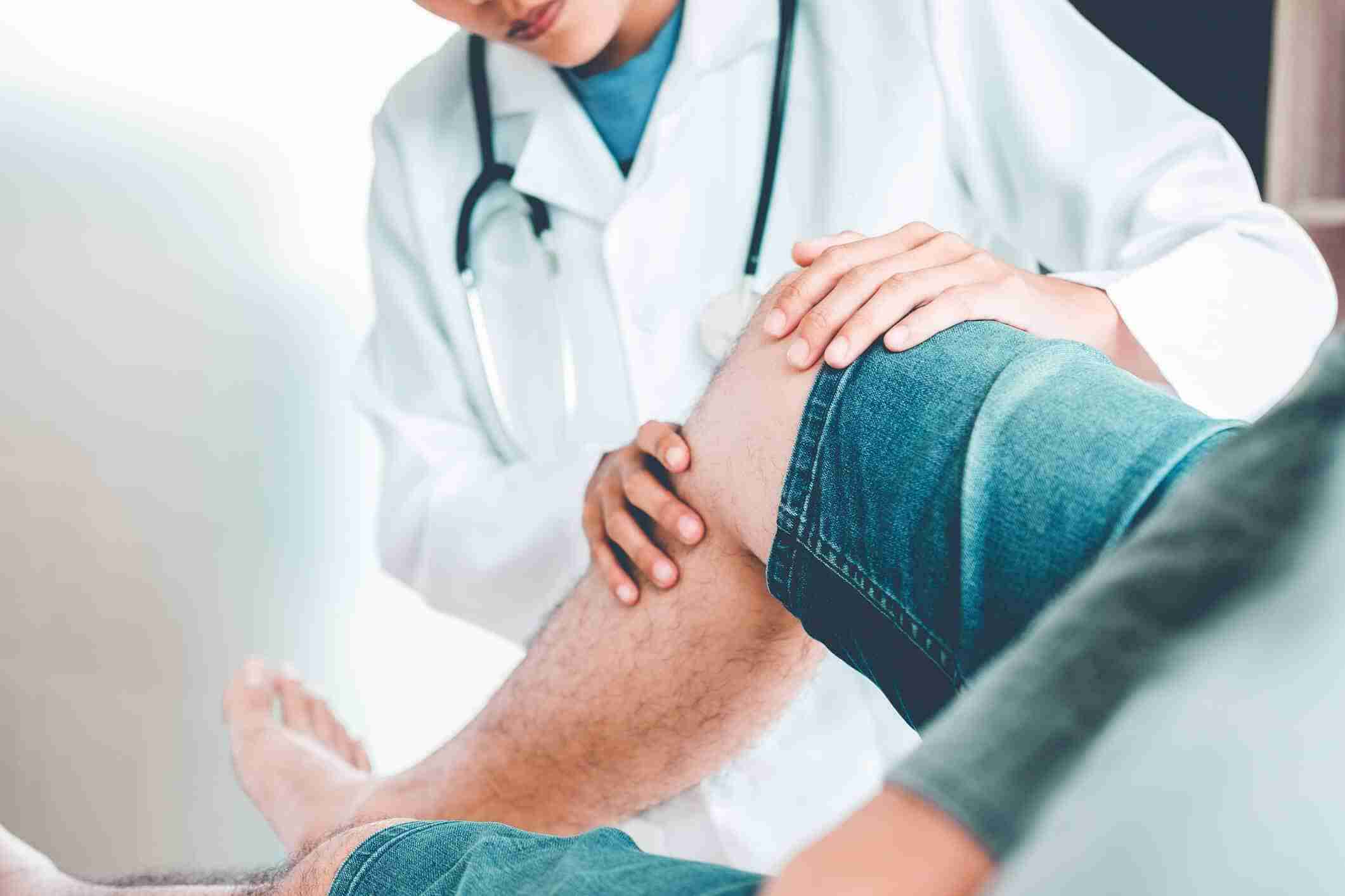 Doctor treating a patient with a knee problem